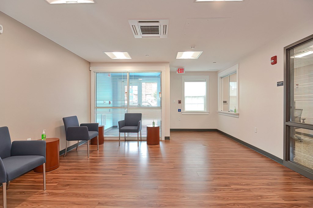 a large room with chairs and a table in front of a window