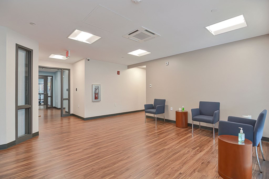a large room with chairs and tables and a wood floor