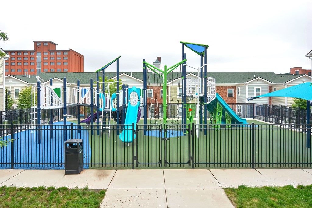 a playground at a school with a trash can