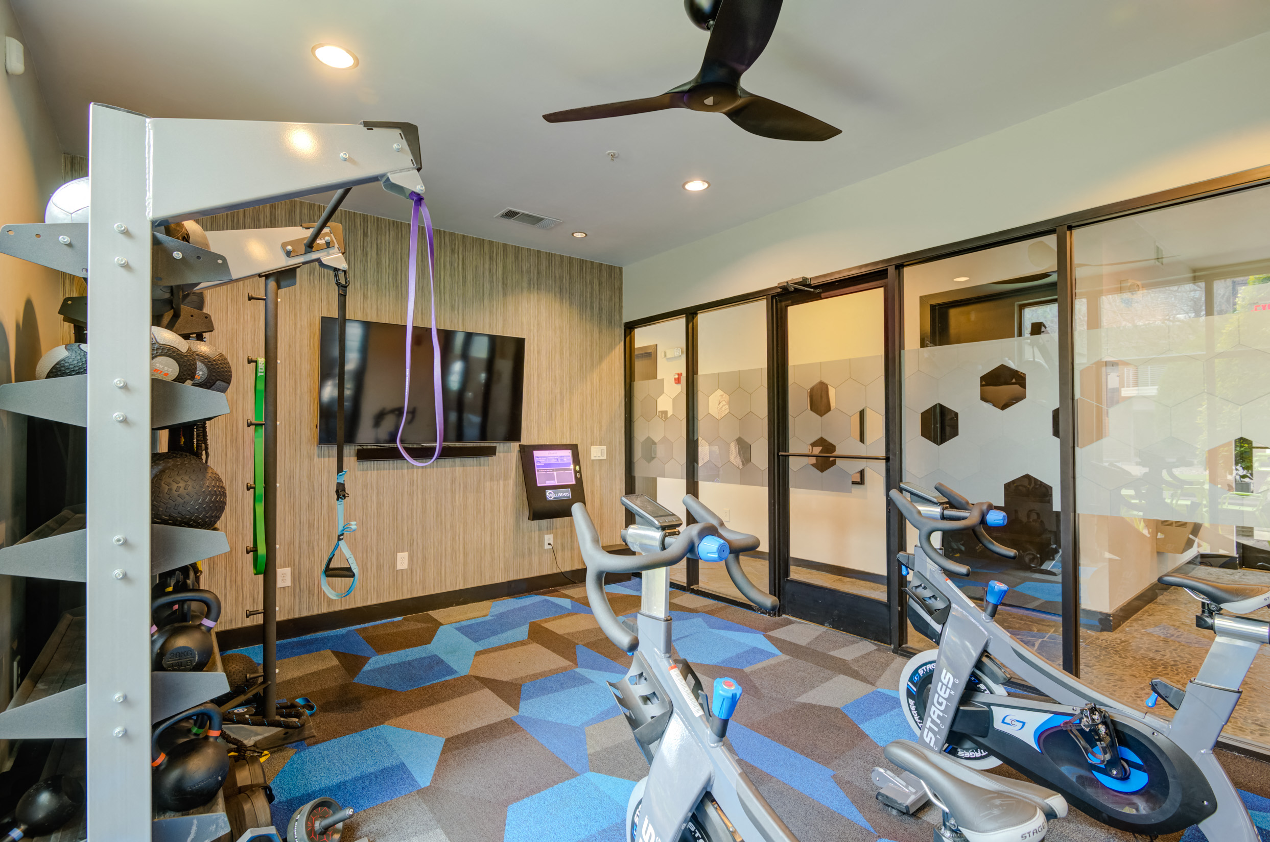 a home gym with exercise bikes and a tv