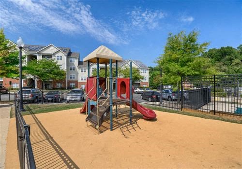 a playground with a swing set in a park