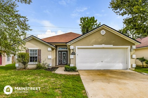 a beige house with a white garage door