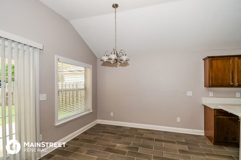the kitchen and dining room of a home with a large window