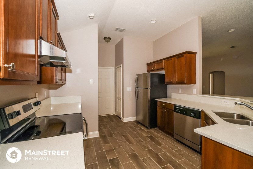 a kitchen with stainless steel appliances and wooden cabinets