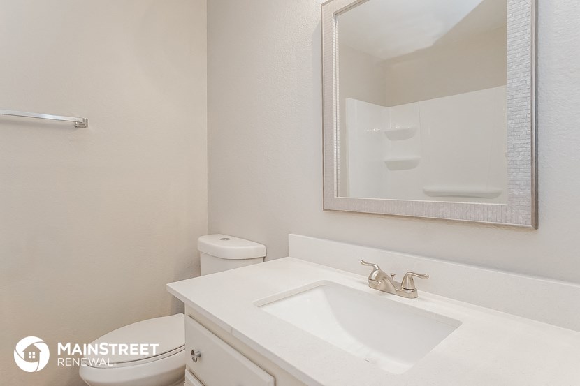 a bathroom with a sink and a mirror and a toilet