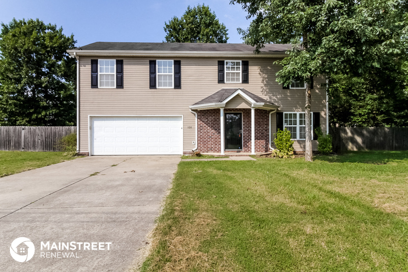 a beige house with a white garage door