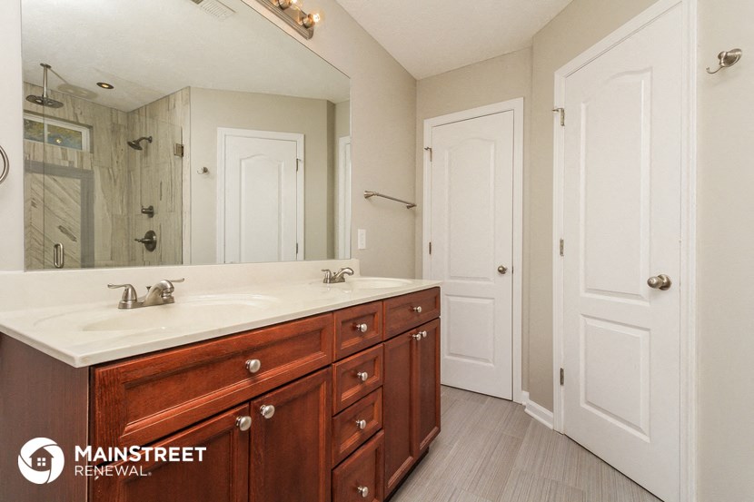 a bathroom with a sink and a mirror and a shower