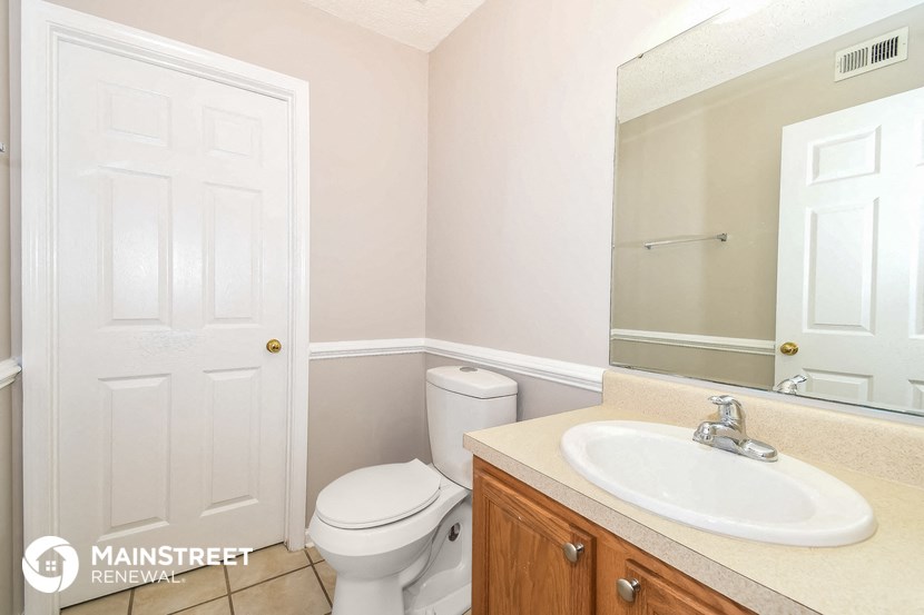 a bathroom with a toilet and a sink and a mirror