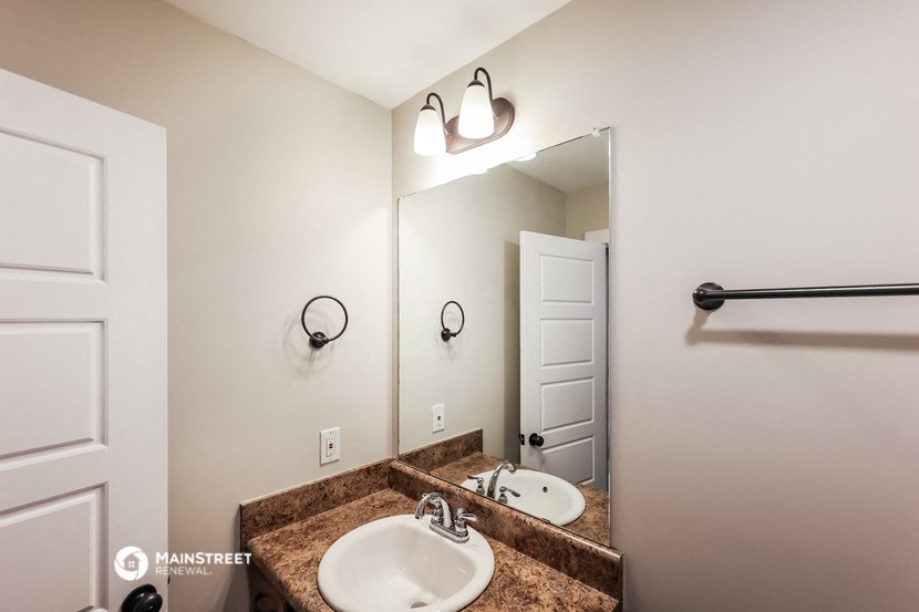 a bathroom with a sink and a mirror