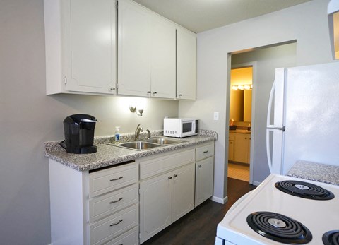 a kitchen with a stove sink and refrigerator