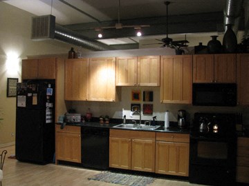 a kitchen with black appliances and wooden cabinets