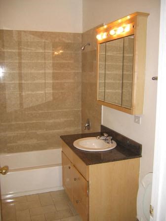a bathroom with a sink and a tub and a mirror