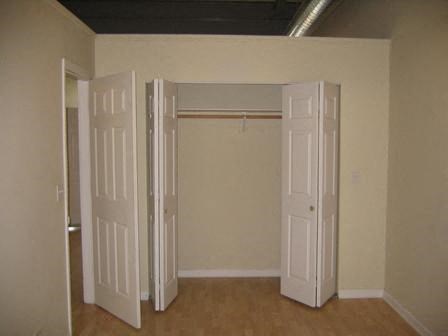 an empty room with three open doors in it