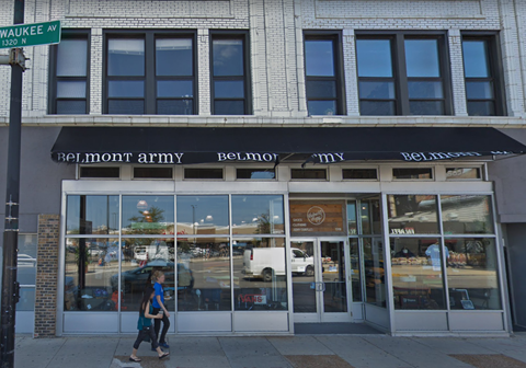 A woman walks past a Belmont Army storefront.