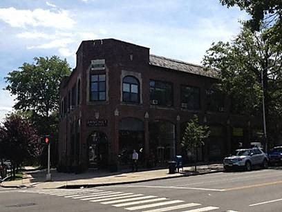 A red brick building with a white sign on it.