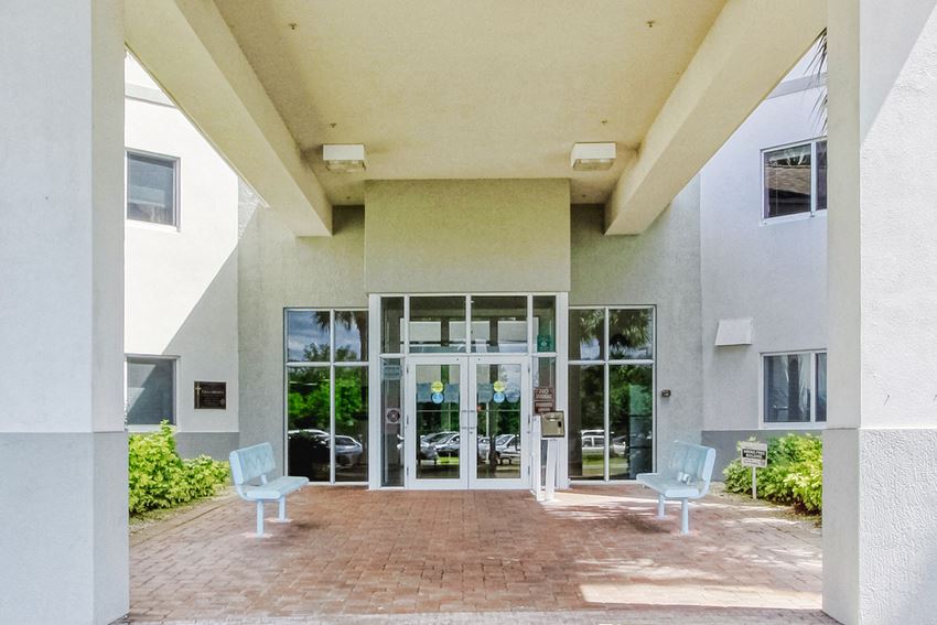 CoveredEntrance covered entrance with benches and shrubs