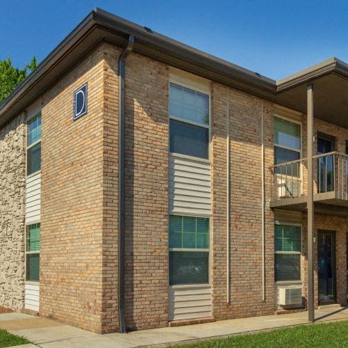 Condos at the Villager Building D Exterior with Walkways and Lush Landscaping