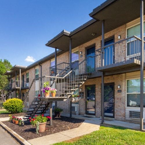Condos at the Villager Apartment Building Exterior with Two-Levels and Landscaped Walkways