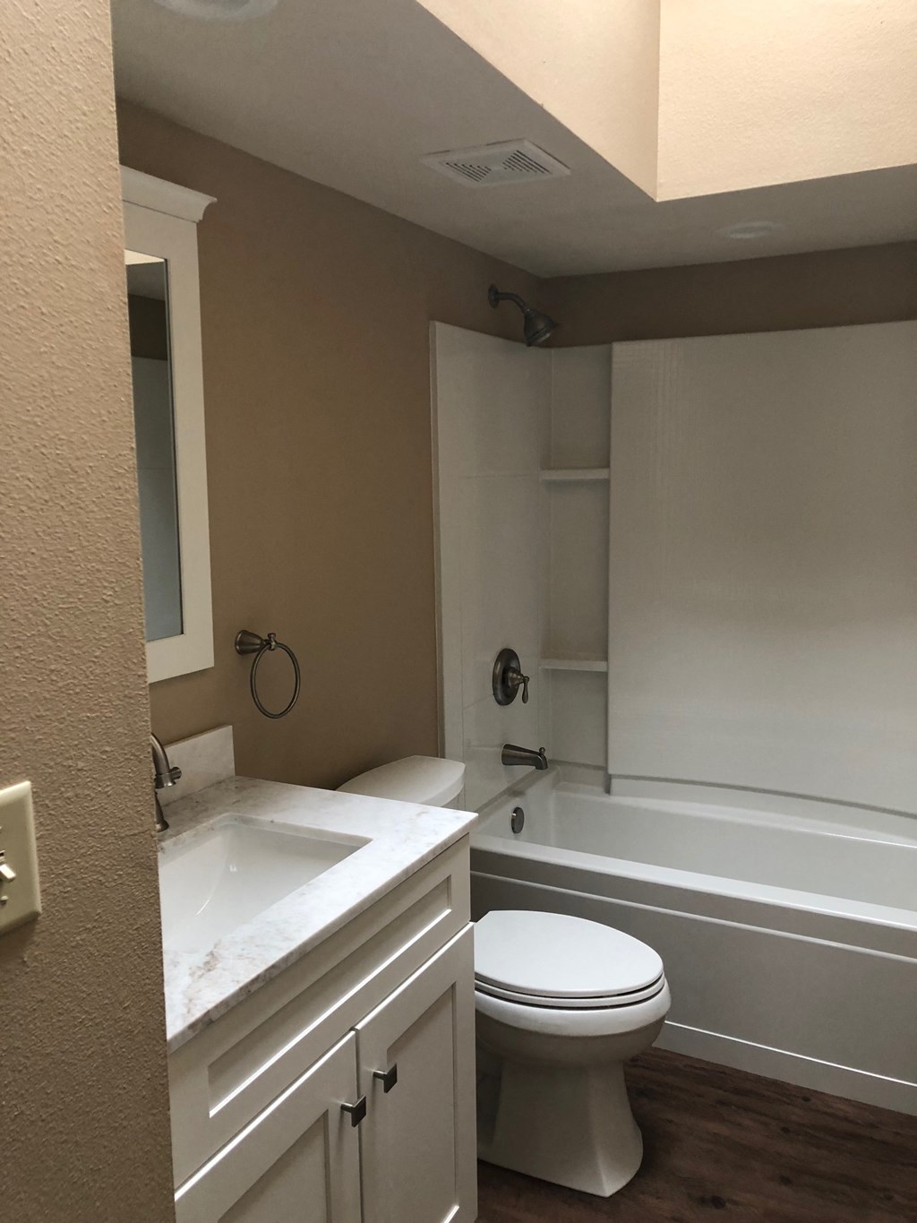 a bathroom with a toilet and a tub and a sink