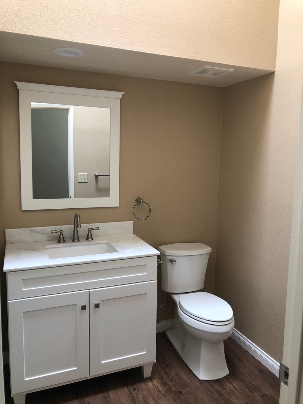 a bathroom with a toilet and a sink and a mirror