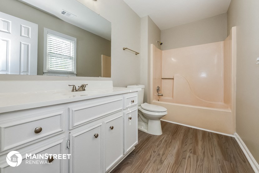 a bathroom with a white sink and a toilet and a shower