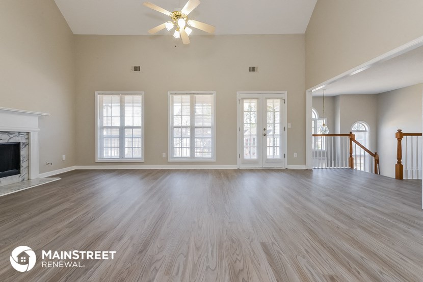 the living room and dining room of an empty house