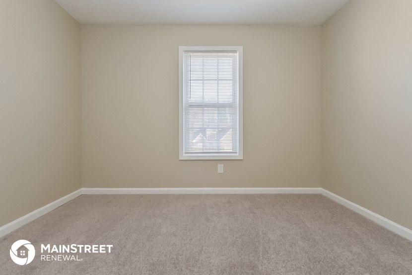 a room with carpet and a window in it