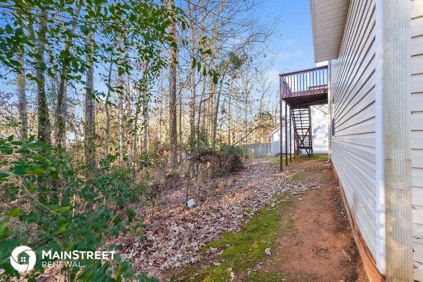the path to the deck of a house in the woods