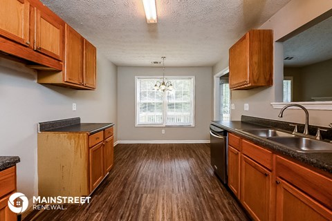 a kitchen with wooden cabinets and a sink and a window