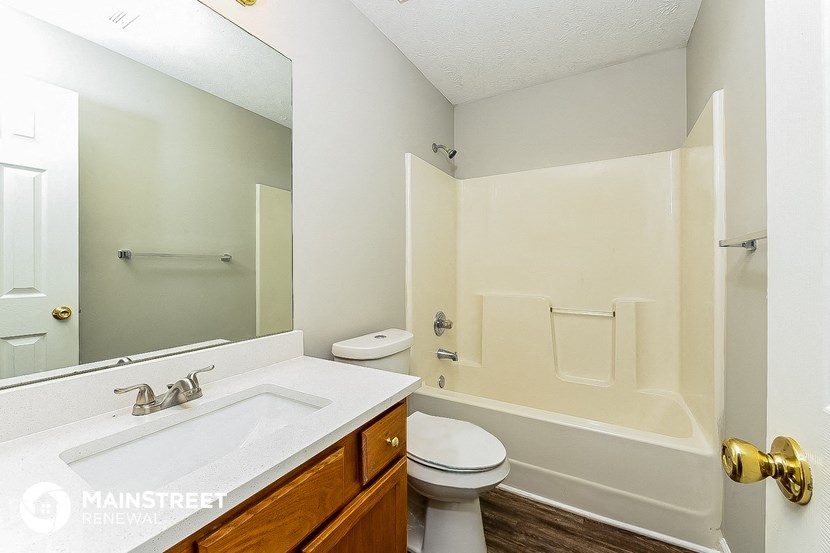 a bathroom with a sink toilet and a tub