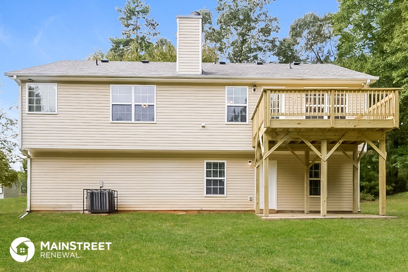 the back of a house with a deck and a porch