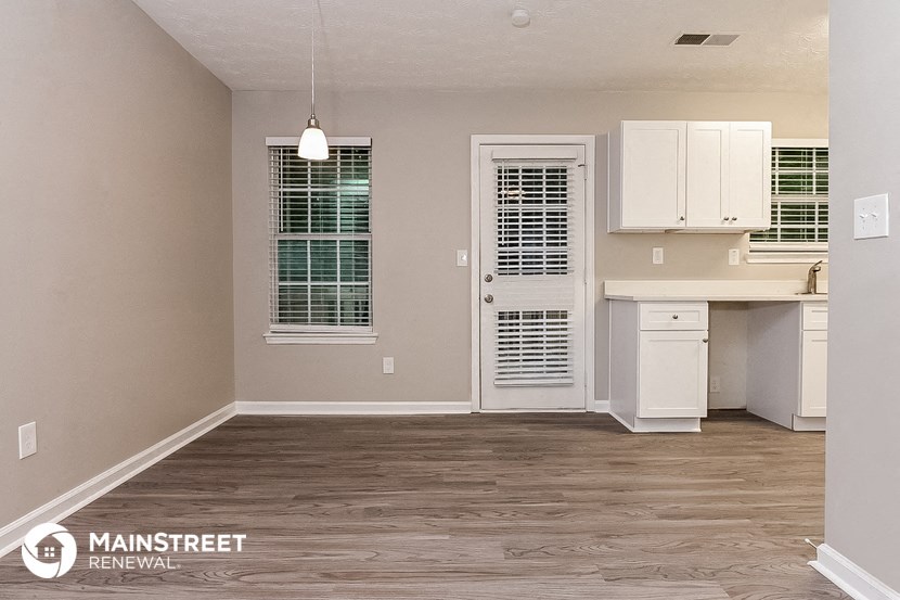 the kitchen and living room of a renovated apartment