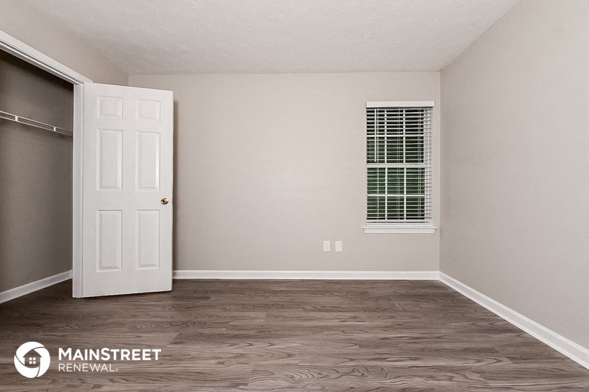 a bedroom with a closet and a white door