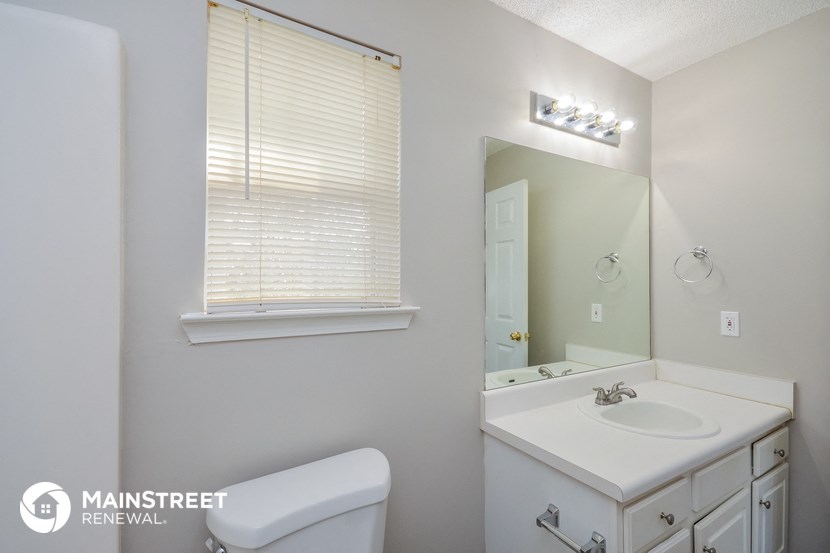a bathroom with a sink and a mirror and a toilet