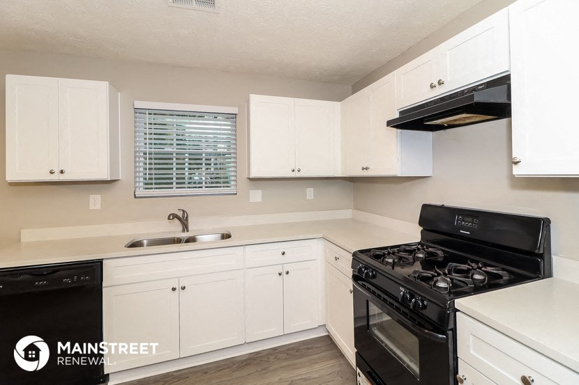 the preserve at ballantyne commons apartment kitchen with black appliances and white cabinets