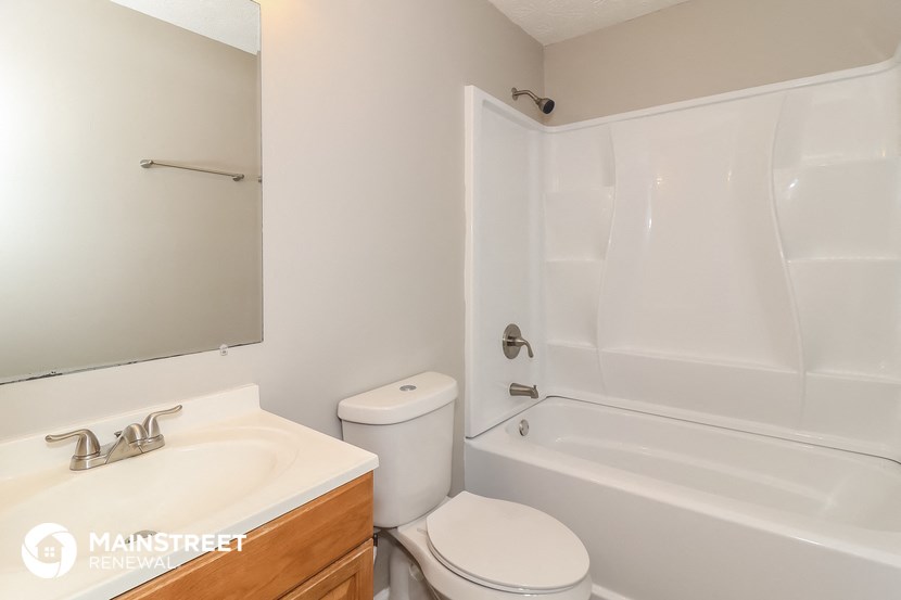a bathroom with a sink toilet and a bath tub