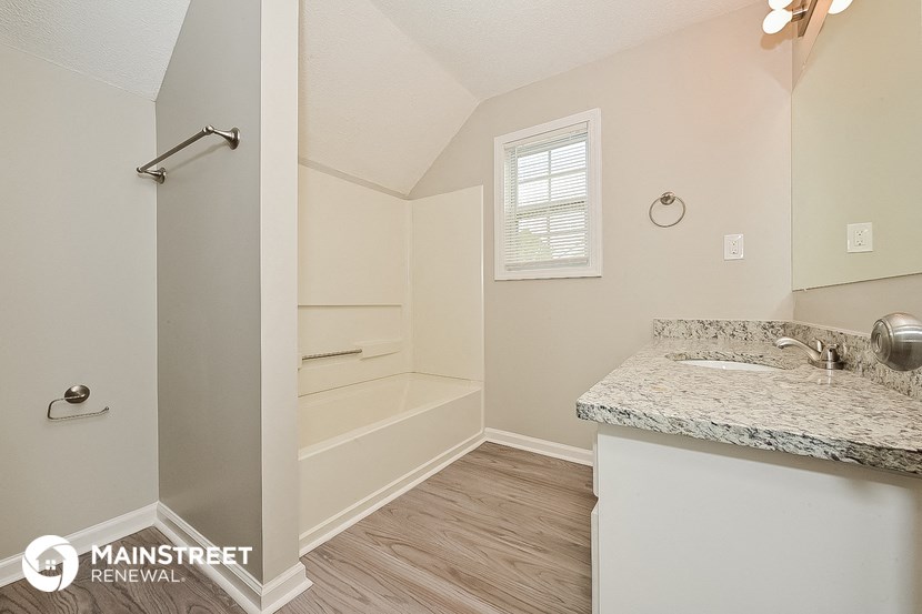a bathroom with a sink and a shower and a bath tub