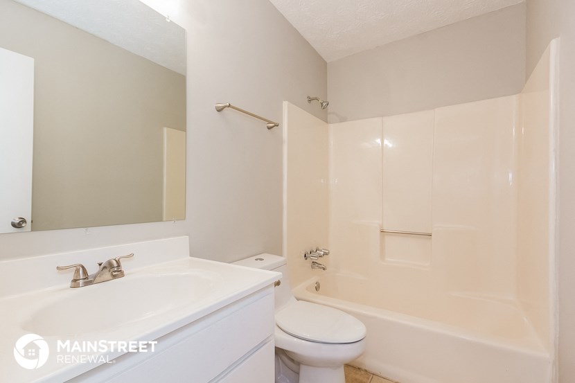 a bathroom with a sink toilet and a tub