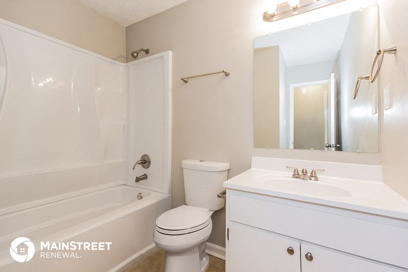 a bathroom with a sink toilet and a tub