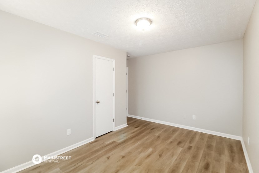 the living room and dining room of a house with wood flooring