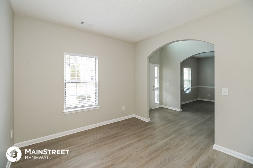 the living room and dining room of an apartment