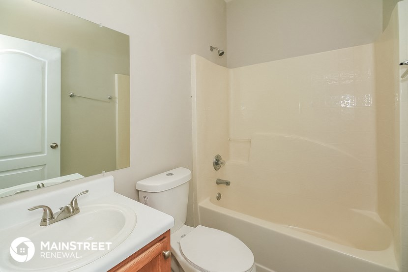 a bathroom with a sink toilet and a shower
