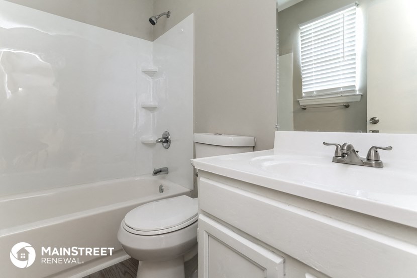 a bathroom with a sink toilet and a tub