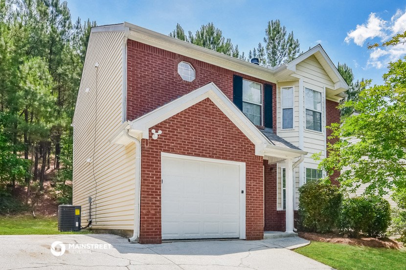 a brick house with a white garage door