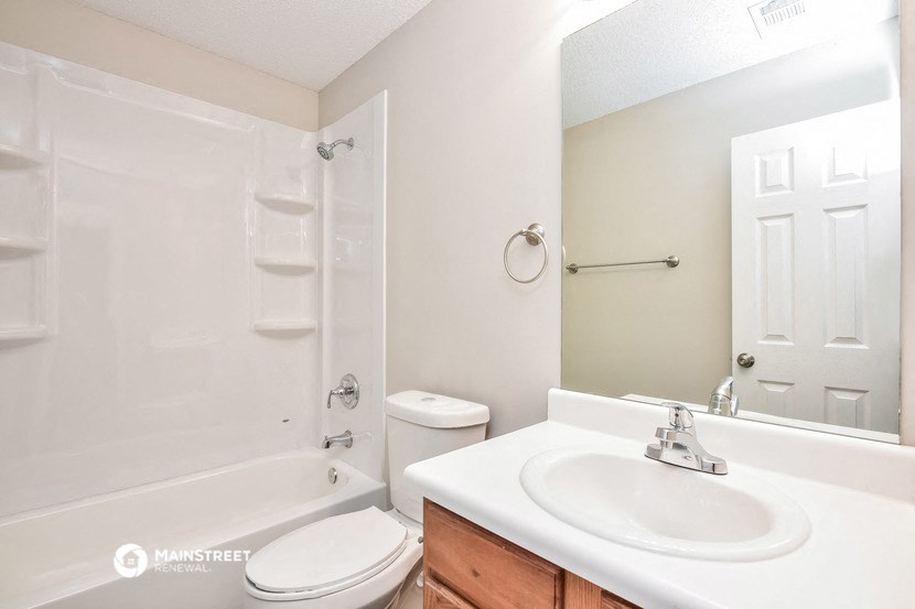 a bathroom with a sink toilet and a shower
