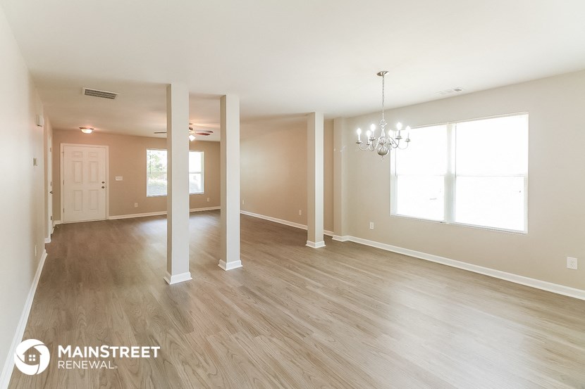 the living room and dining room of an open floor plan