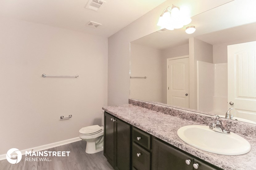 a bathroom with a sink and a toilet and a mirror