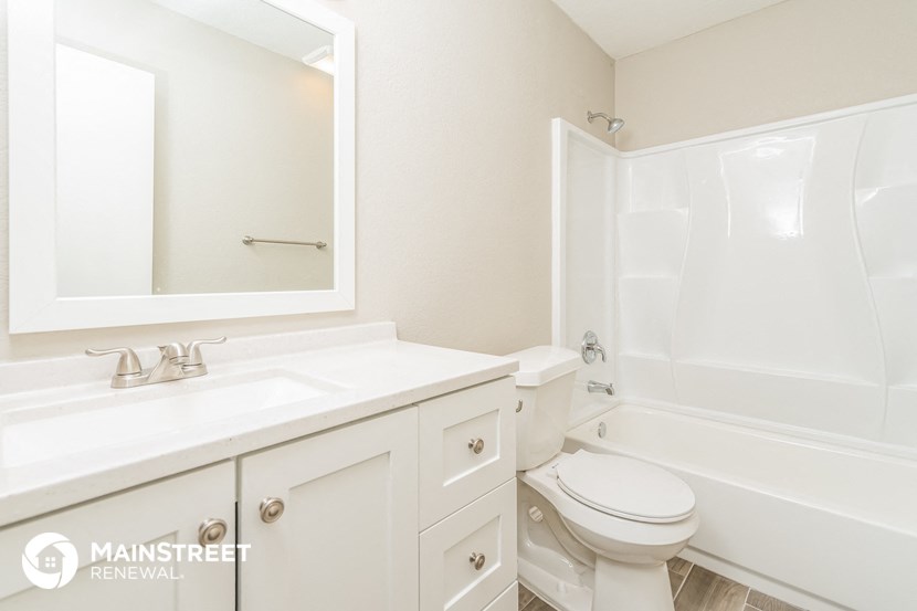 a bathroom with a sink toilet and a bath tub