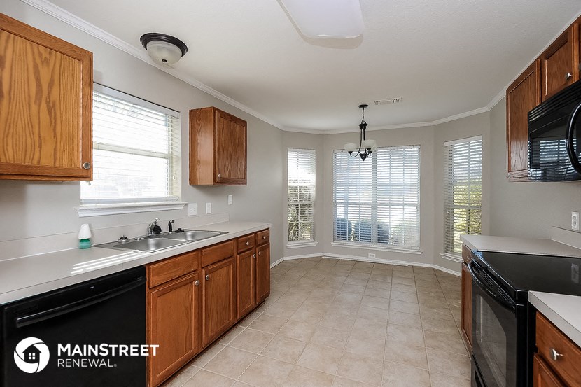 a kitchen with a sink and a stove and a window