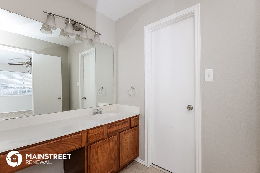 the master bathroom has a large mirror and a large sink